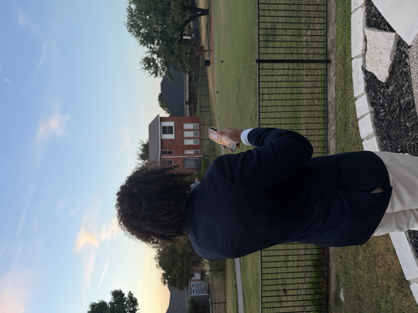 Ejay Weaver on his phone outside a family's home